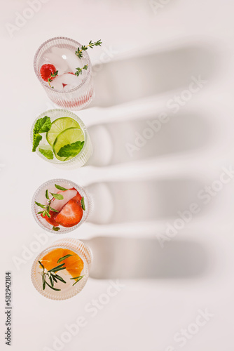 Top view of ribbed glasses with lemonade or infused water with different flavors photo