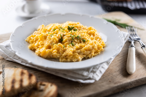 Appetizing breakfast full of proteins in a form of scrambled eggs in a plate