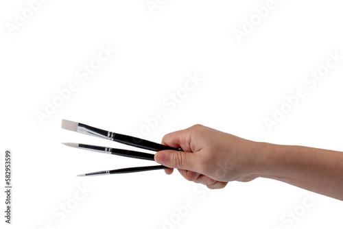 Hand using a little paintbrush isolated on a transparent background