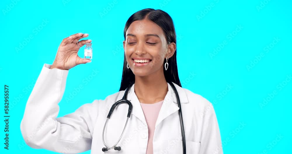 Studio woman, vaccine and happy doctor, female surgeon or nurse with covid 19 or disease cure. Medical portrait, medicine bottle container or science hospital innovation on blue background Studio woman, vaccine and happy doctor, female surgeon or nurse with covid 19 or disease cure. Medical portrait, medicine bottle container or science hospital innovation on blue background