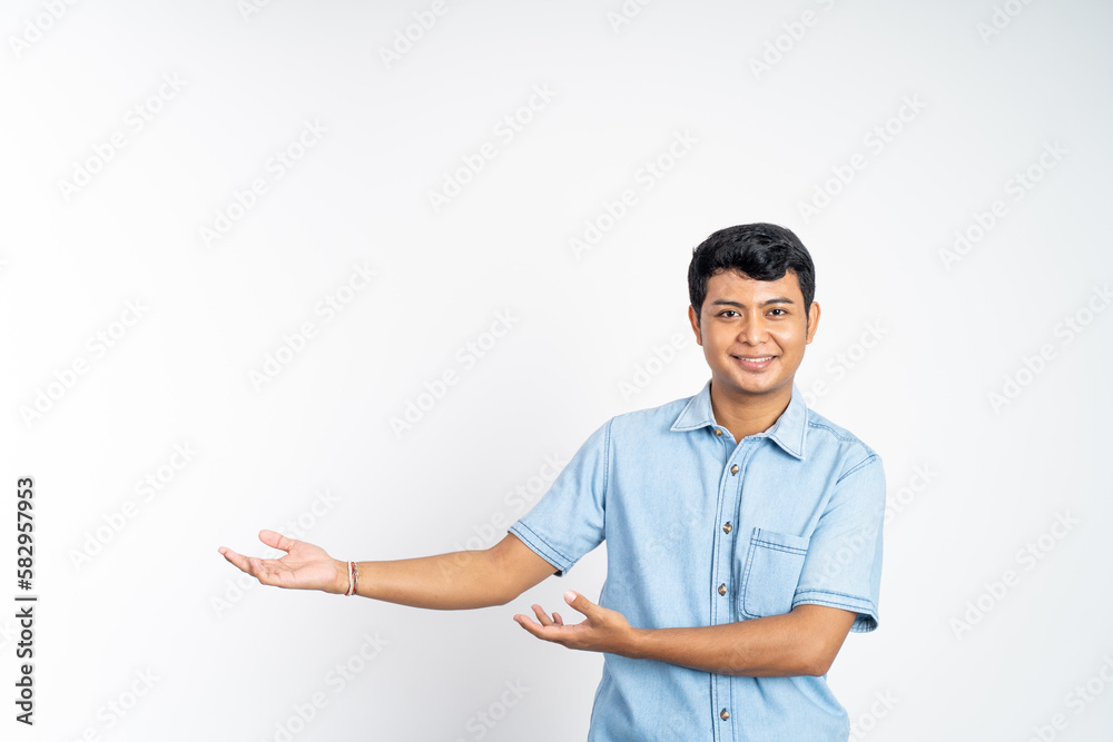 Asian youth standing with both hands presenting something with copyspace an isolated background Asian youth standing with both hands presenting something with copyspace an isolated background