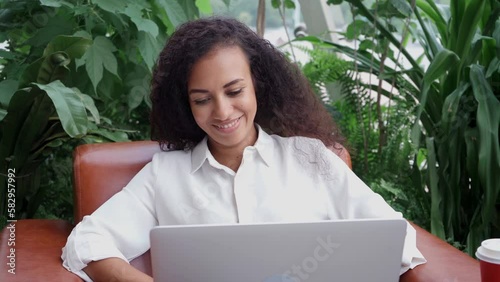 young business woman using laptop in office lobby.