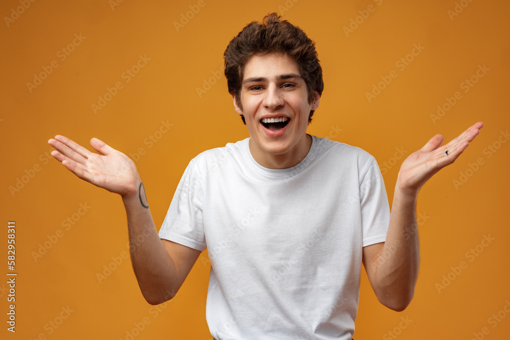 Young man standing over yellow background clueless and confused with open arms Young man standing over yellow background clueless and confused with open arms