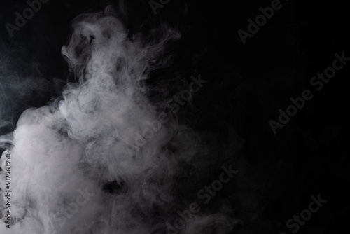 Cloud of white smoke on a black background closeup