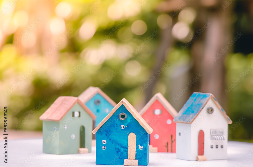 Naklejka premium Wood block with wooden houses. Planning Buy Real Estate, Planning to buy the property. concept of Choose the best. building and architecture business.
