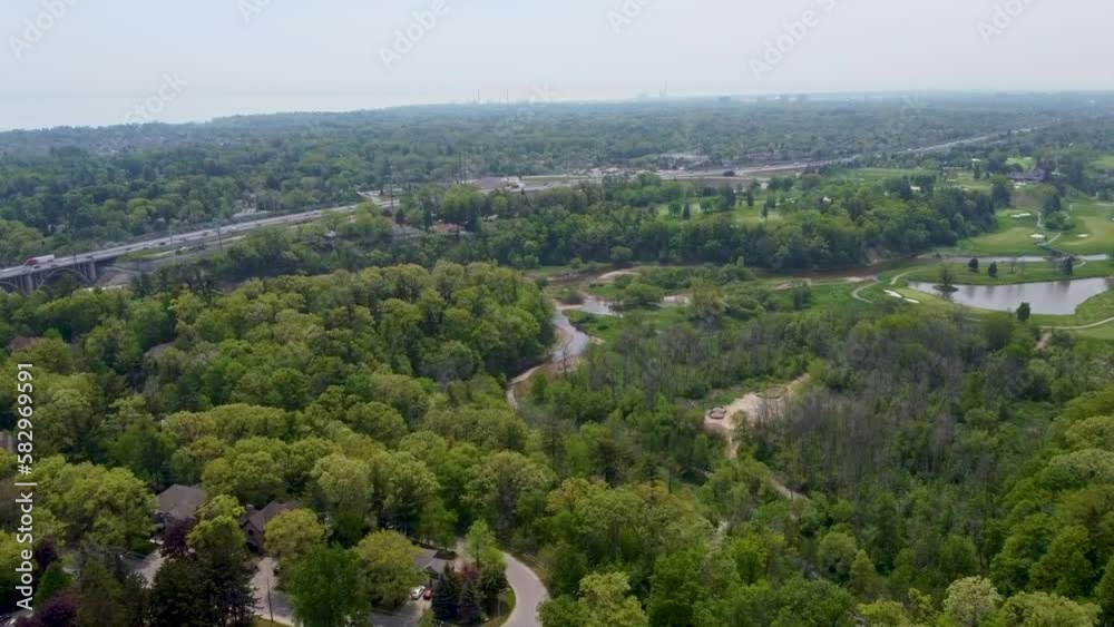 Flying over green space in Mississauga with a golf course and the QEW on the background. Flying over green space in Mississauga with a golf course and the QEW on the background.
