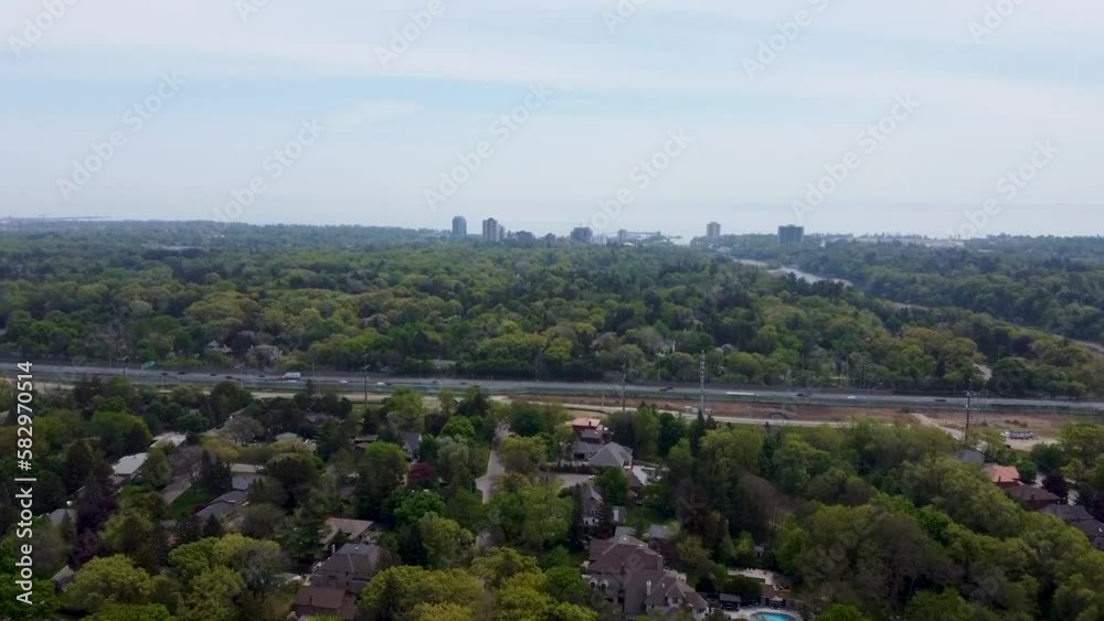 Drone flying toward QEW in Mississauga with Lake Ontario in the distance. Drone flying toward QEW in Mississauga with Lake Ontario in the distance.