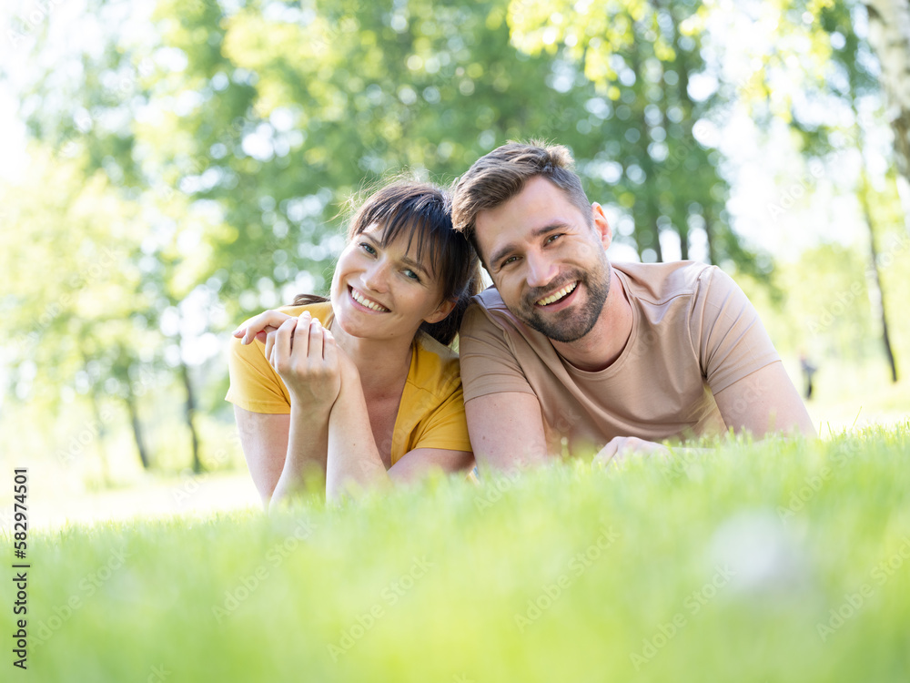 Couple laying at grass in field Couple laying at grass in field