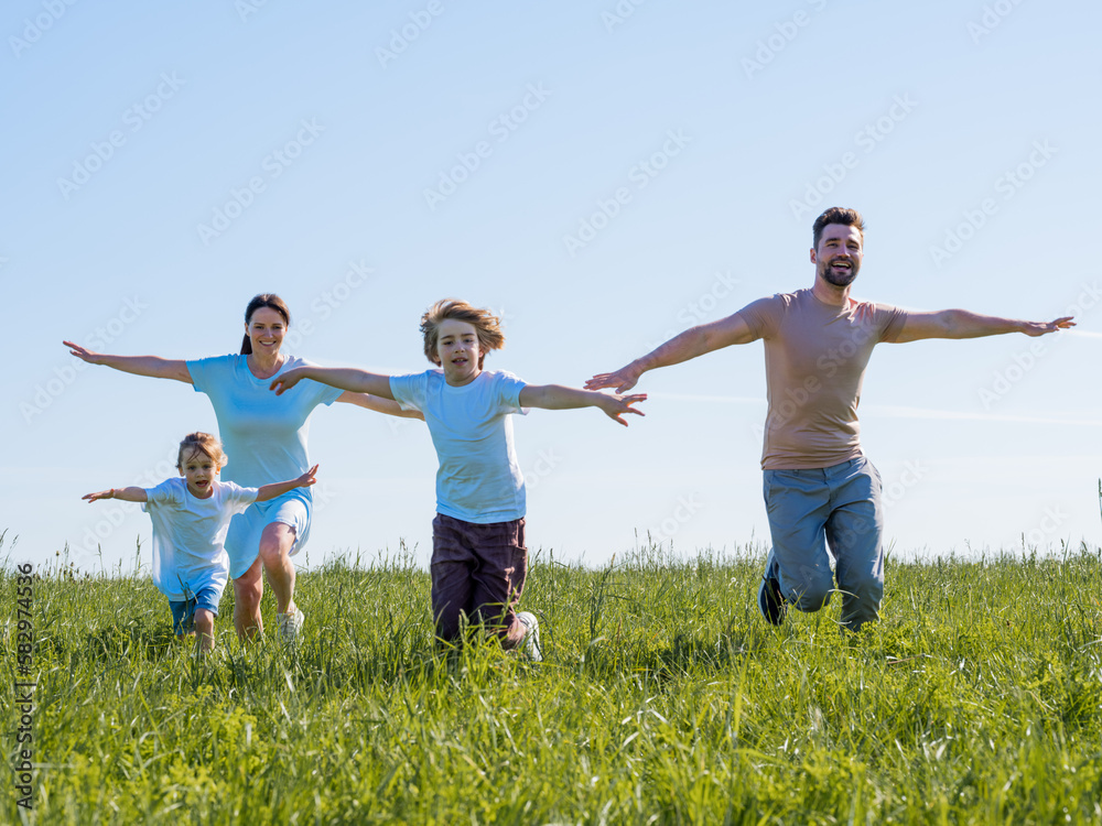 Family running with outstretched arms