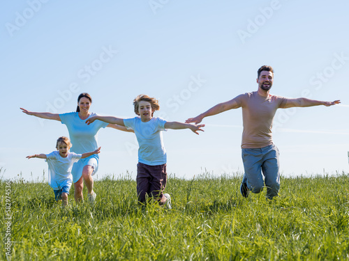 Family running with outstretched arms
