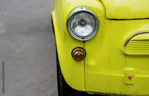 headlights of old yellow car