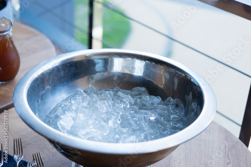 Crystal clear ice cubes as background. food ice. Large bowl with ice cubes.