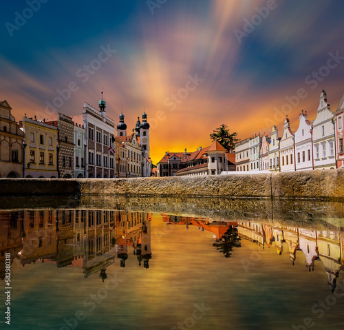 View of Telc across pond with reflections, South Moravia, Czech Republic.