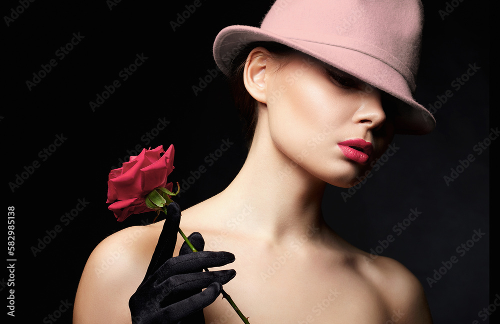 Fototapeta premium Beautiful young Woman In Hat and Gloves holding Flower