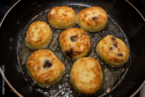 Homemade tasty cheesecakes are fried in pan,  traditional dish Ukrainian