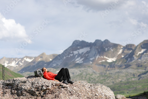 Hiker resting on the top of a mountain