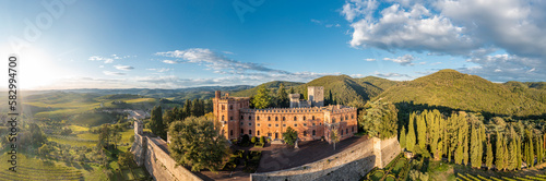 Italy, Tuscany, San Regolo, Aerial view ofCastello di Brolio and surrounding landscape at summer sunset photo