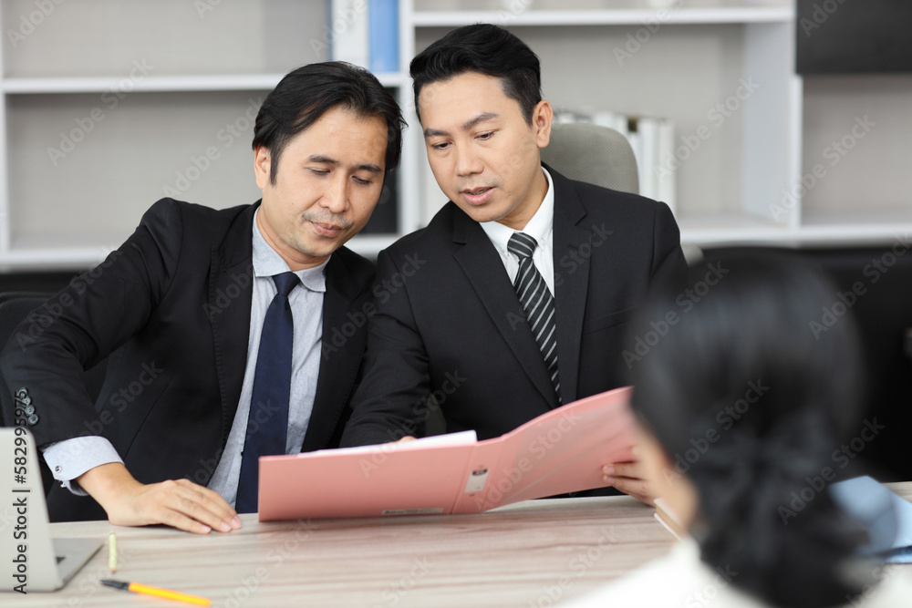 Human resources department managers sitting and interviewing female businesswoman applicant or candidate during job interview in modern office. Business recruitment concept Human resources department managers sitting and interviewing female businesswoman applicant or candidate during job interview in modern office. Business recruitment concept