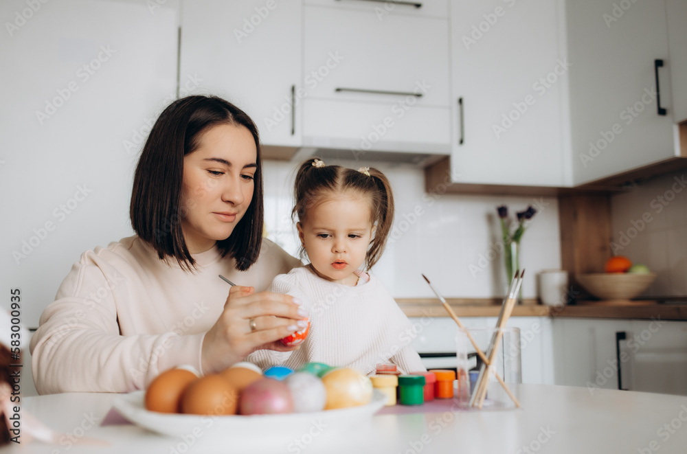Happy easter. A mother and her daughter painting Easter eggs. Happy easter. A mother and her daughter painting Easter eggs.
