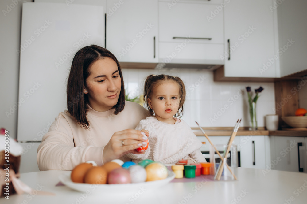 Happy easter. A mother and her daughter painting Easter eggs. Happy easter. A mother and her daughter painting Easter eggs.