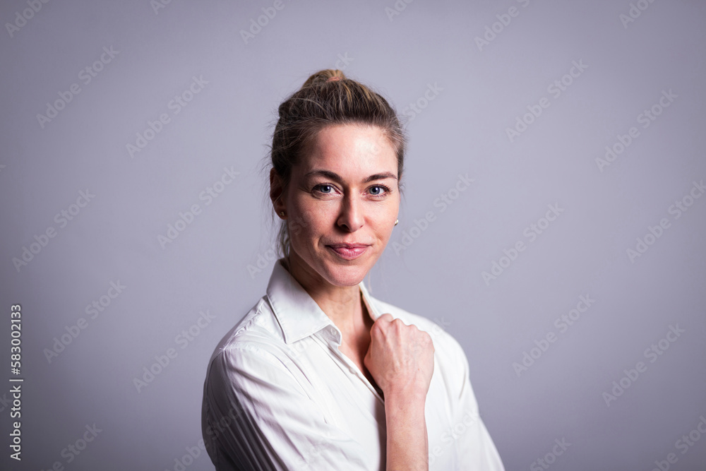 Smiling mature businesswoman against gray background Smiling mature businesswoman against gray background