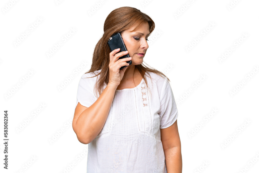 Middle-aged caucasian woman over isolated background keeping a conversation with the mobile phone with someone Middle-aged caucasian woman over isolated background keeping a conversation with the mobile phone with someone