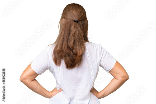 Middle-aged caucasian woman over isolated background in back position