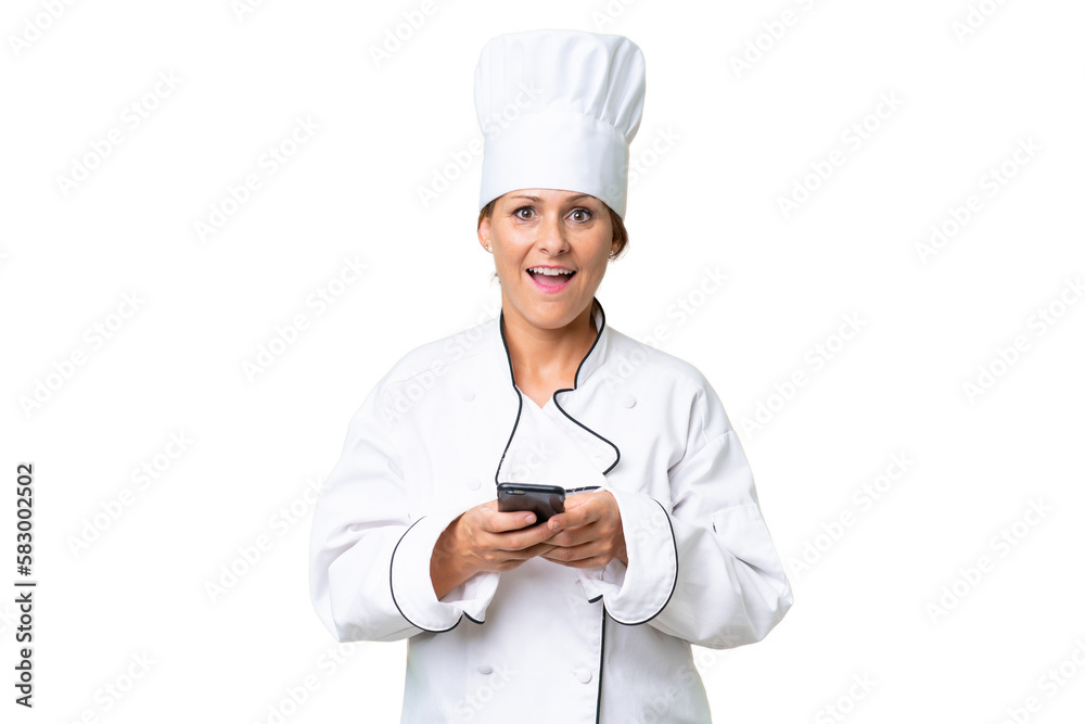 Middle-aged chef woman over isolated background surprised and sending a message