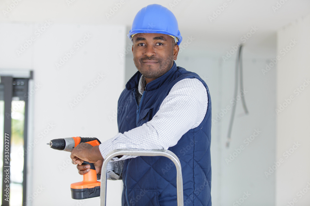 happy male builder standing on ladder happy male builder standing on ladder