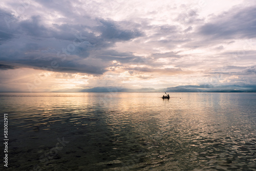 Sea under cloudy sky at sunset