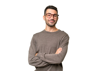 Young handsome caucasian man over isolated background with arms crossed and looking forward