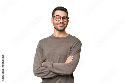Young handsome caucasian man over isolated background with arms crossed and looking forward