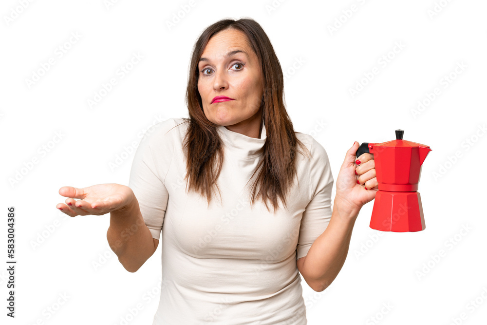 Middle-aged caucasian woman holding coffee pot over isolated background making doubts gesture while lifting the shoulders Middle-aged caucasian woman holding coffee pot over isolated background making doubts gesture while lifting the shoulders