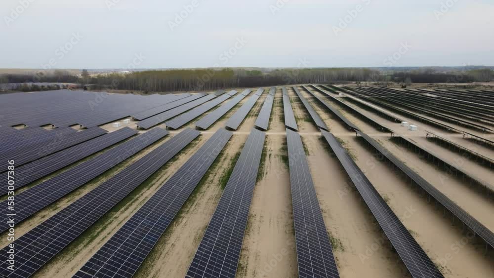 Solar panles producing green energy. Large solar farm in countryside. Drone jib shot Solar panles producing green energy. Large solar farm in countryside. Drone jib shot