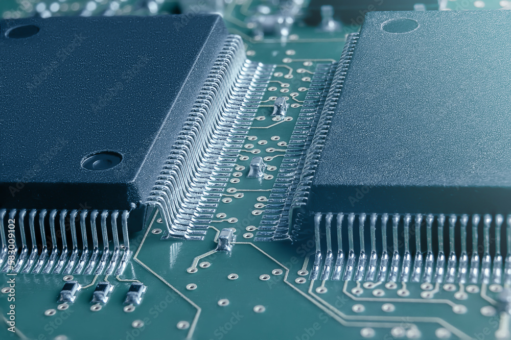 Closeup of Printed Circuit Board with processor, integrated circuits and many other surface mounted passive electrical components. Closeup of Printed Circuit Board with processor, integrated circuits and many other surface mounted passive electrical components.