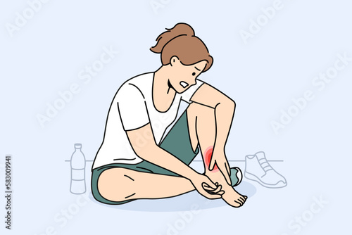 Unhealthy woman sit on floor in gym touch hurt ankle. Unwell girl suffer from trauma or injury exercising or doing sports. Vector illustration. 