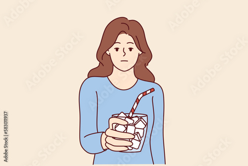 Emotionless girl holds glass full of sugar with straw symbolizing unhealthy nutrition leading to diabetes. Woman drinking drinks with too much sugar needs diet to avoid insulin problems 