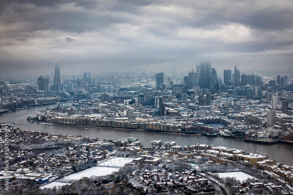 Panoramic view of the London skyline during a winter day with low clouds and snow, England