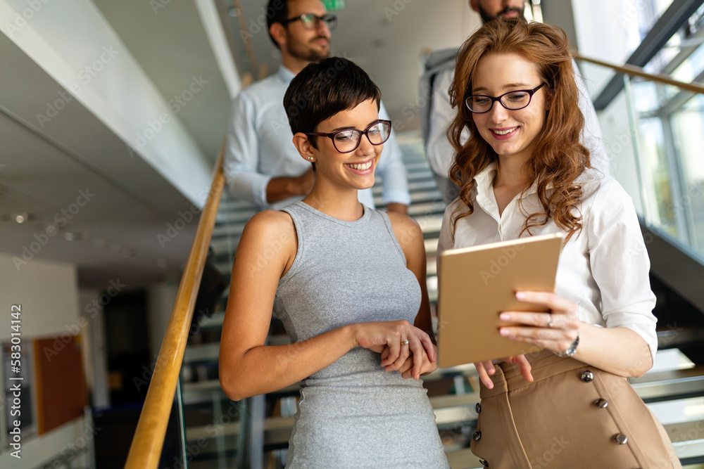 © NDABCREATIVITY - Portrait of two happy success business women talking, having informal meeting in office