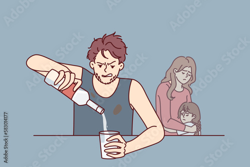 Drinking father sitting at table, pours vodka into glass, ignoring upset wife and little daughter. Alcoholic man with unshaven face drinks vodka, causing inconvenience to cohabitant and child 