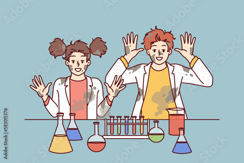 Funny children in laboratory raise hands after unexpected reaction when mixing chemical reagents that caused explosion. Children doing science experimenting in school lab and doing research 