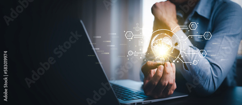 Man working and holding light bulb on the desk, Idea, innovation, and inspiration concept, creativity with hand draw light bulbs that shine glitter, new ideas with innovative technology and creativity