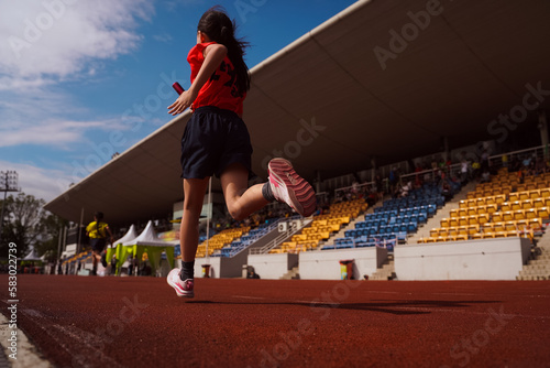 person running on the stadium track