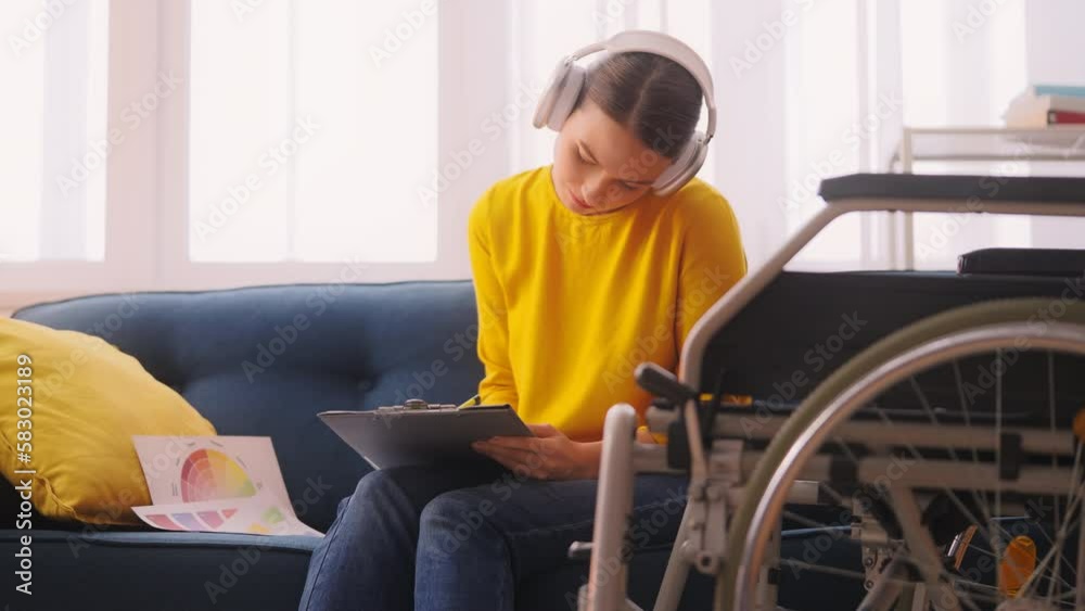 Female artist with disability wearing headset and drawing sketches, creativity Female artist with disability wearing headset and drawing sketches, creativity