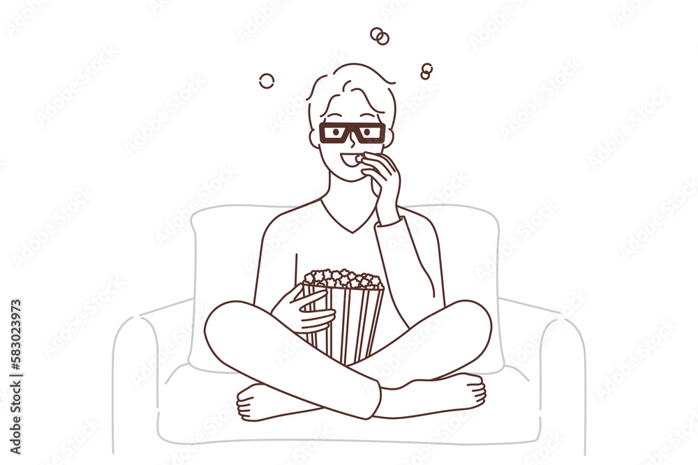 Smiling guy watching movie eating popcorn 