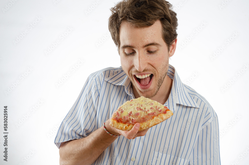 A man smiles as he looks at a piece of pizza. Isolated white background for text space A man smiles as he looks at a piece of pizza. Isolated white background for text space