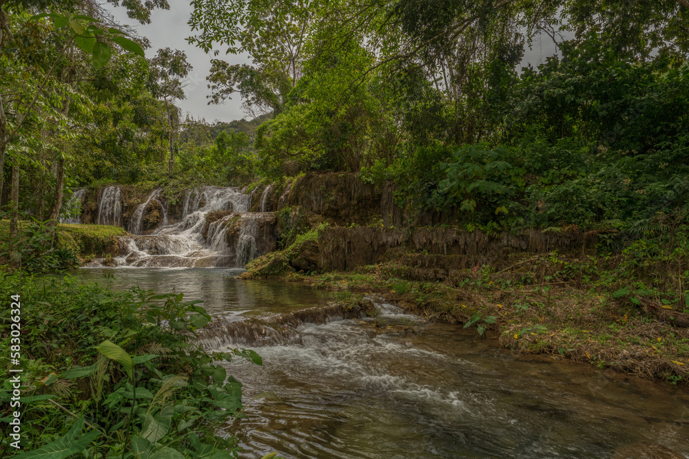 beautiful mexican waterfall hidden in the rainforest
