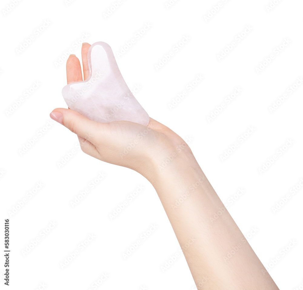 Female hand with rose quartz gua sha tool. Female hand with rose quartz gua sha tool.