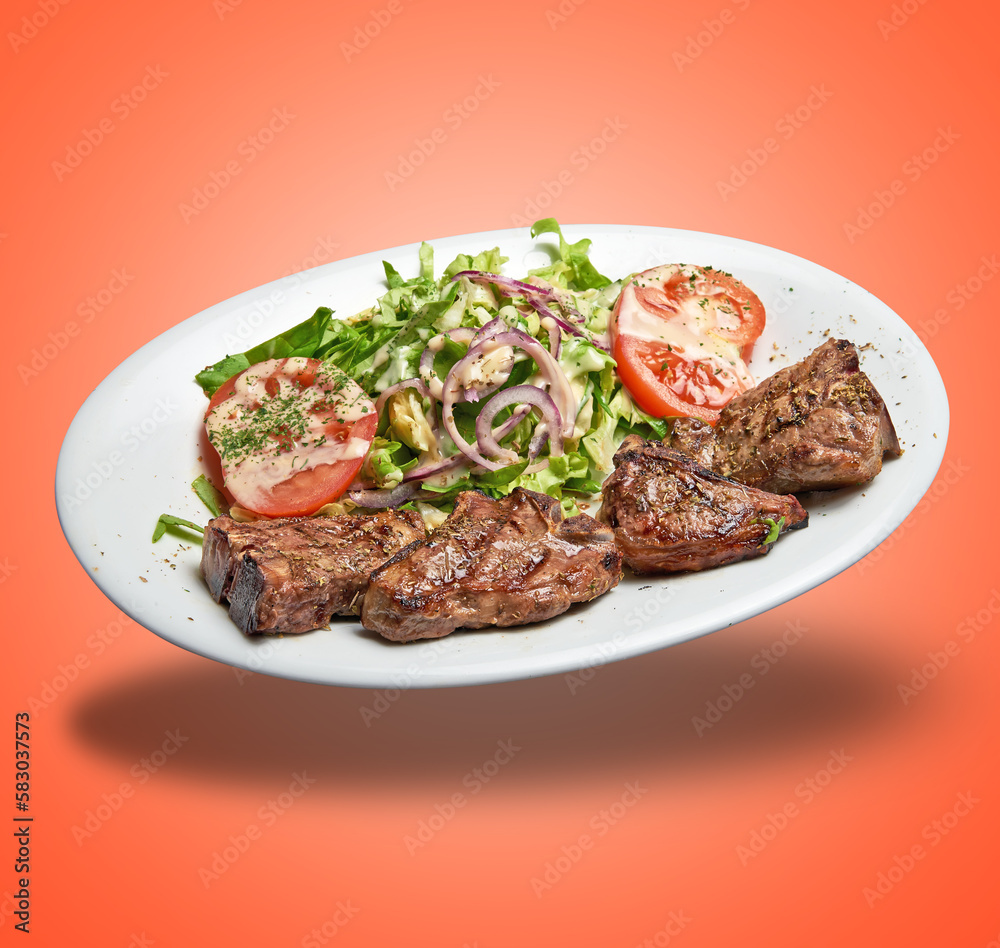Floating White plate with lamb chops and salad Floating White plate with lamb chops and salad