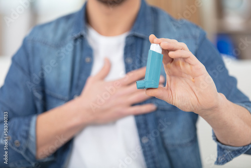 asthma inhaler in a male hands